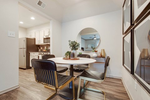 a dining room with a table and chairs and a kitchen